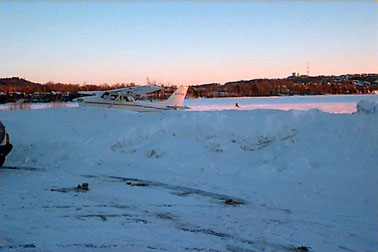 Lone man ice fishing on Elliot Lake