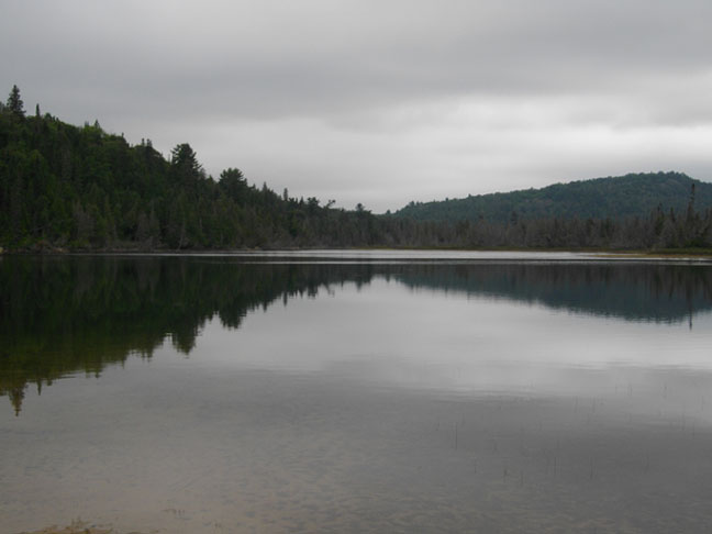 Peaceful reflection on Flack Lake, photo by Janet Coles